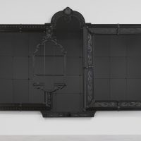 A black and reflective artwork made from the composite of four ornate frames.