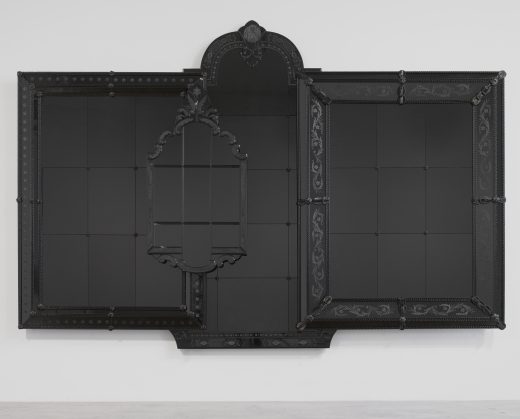 A black and reflective artwork made from the composite of four ornate frames.