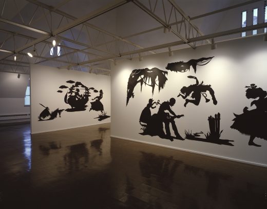 Photograph showing an interior view of the Rennaissance Society gallery with Kara Walkers black silhouette artworks.