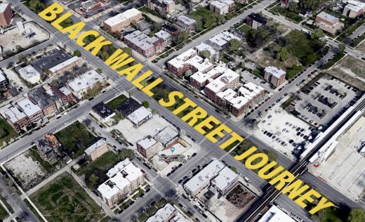 An aerial view of multiple city blocks with bold yellow text superimposed across a major street.