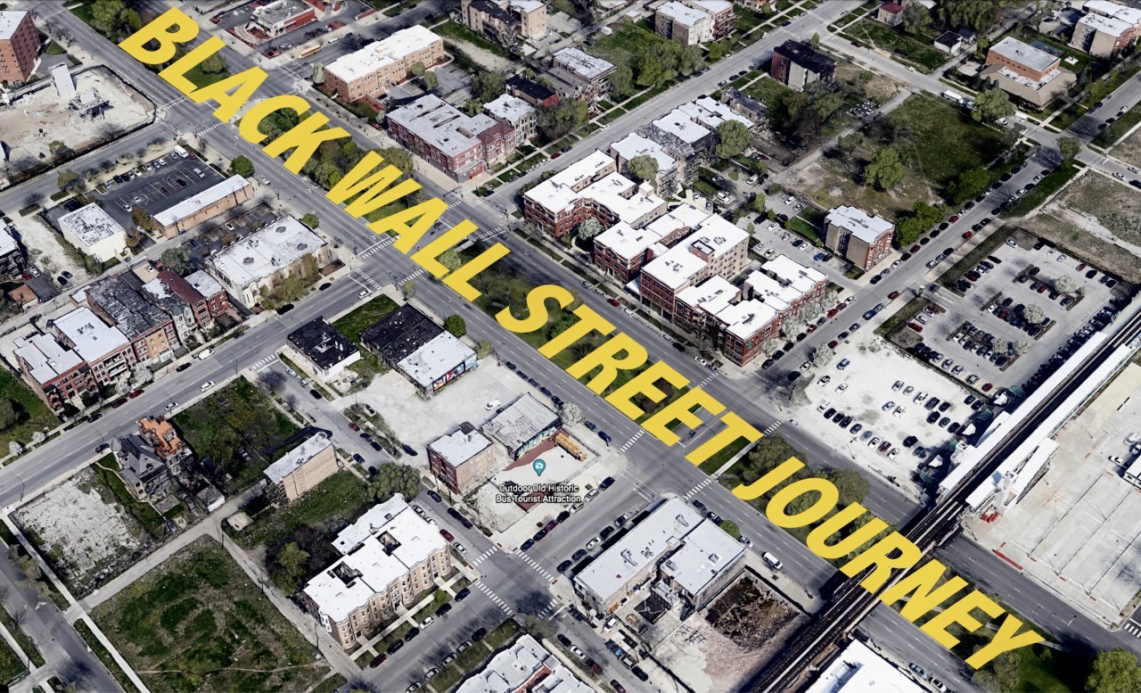 In an aerial image of a Chicago neighborhood, Black Wall Street Journey is digitally painted along a street in yellow capital letters