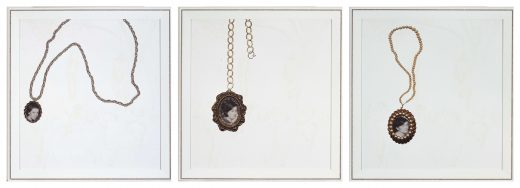 Three prints of locket style necklaces with black and white portraits inside.