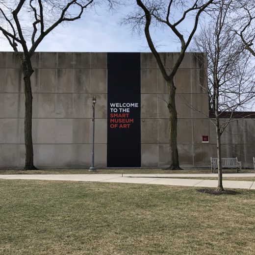 Exterior of the museum with a black banner that reads Welcome to the Smart Museum of Art