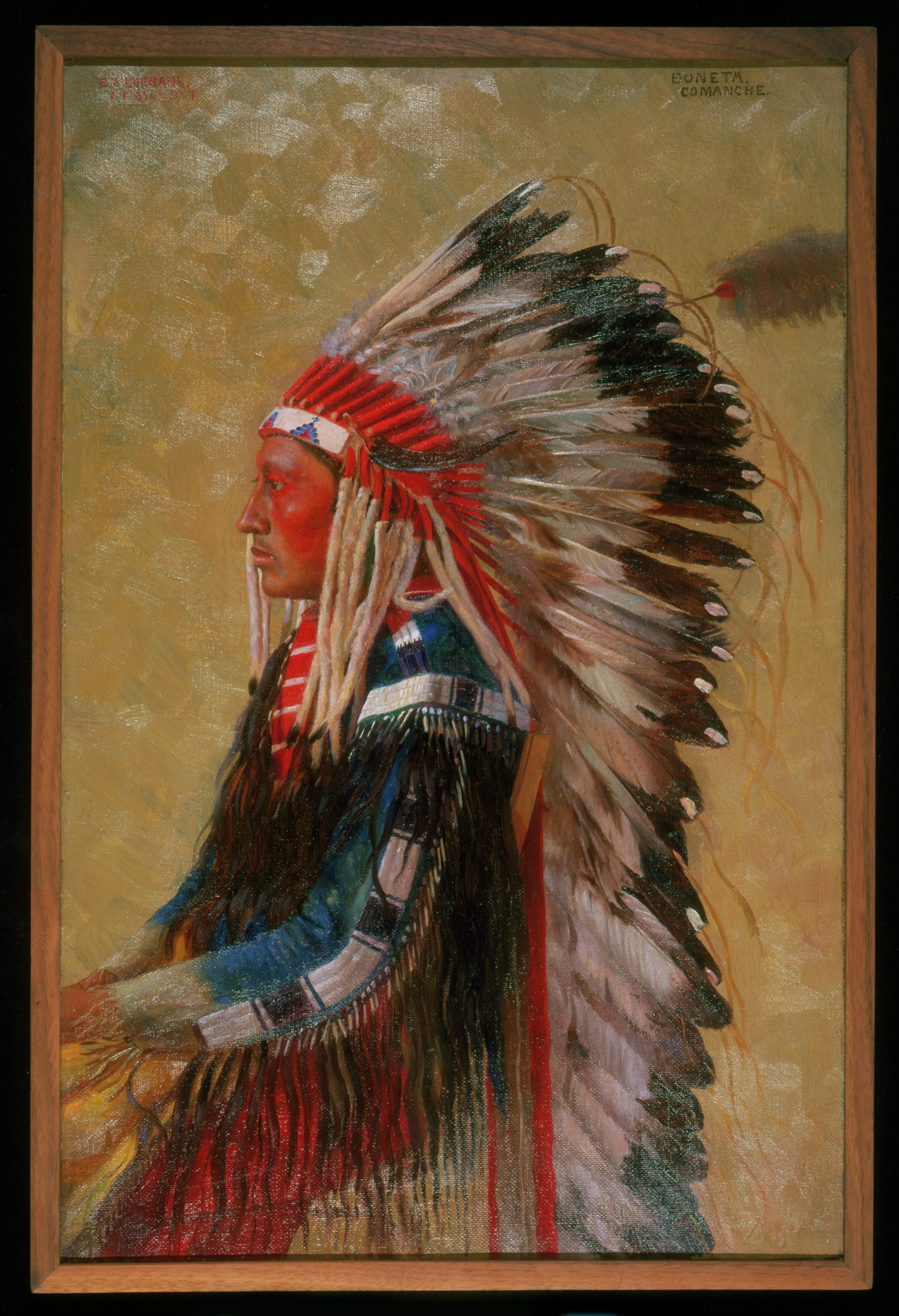 A portrait of a Native American man seated in profile.