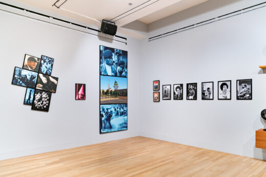 Gallery installation with multiple photographs depicting civil rights era scenes.