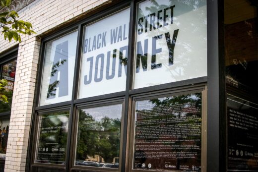 A facade with graphic posters displayed in the windows.