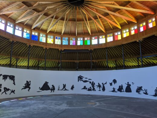 Large figurative black paper silhouettes adorn a round rotunda wall