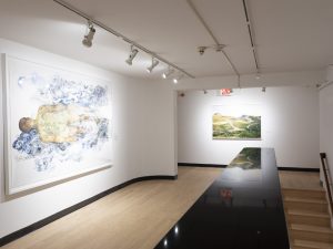 Gallery view with one large scale figure drawing and one landscape photograph