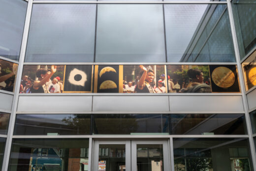 A gold frieze depicting images from the Bud Billiken parade and images of an eclipse and the moon