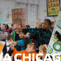 Children hold up their Fundreds on digital poster that reads VIVA Chicago!
