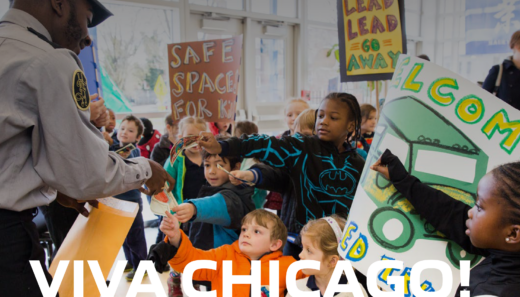 Children hold up their Fundreds on digital poster that reads VIVA Chicago!
